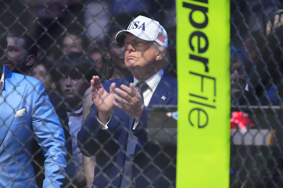 President Donald Trump applauds after Justin Gaethje defeated Ilia Toupruia in the lightweight...