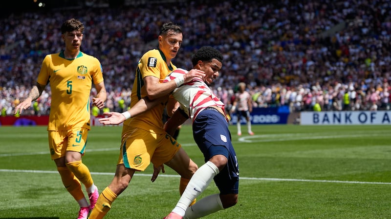 Australia's Paul Okon-Engstler fights for the ball with United States' Weston McKennie, right,...