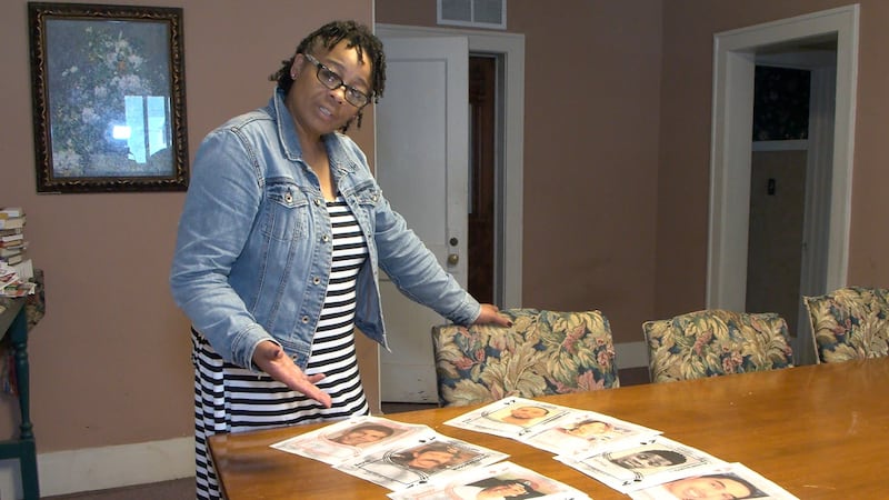 Wallace shows the printout of some of the unsolved murder cases featured on her new deck of...